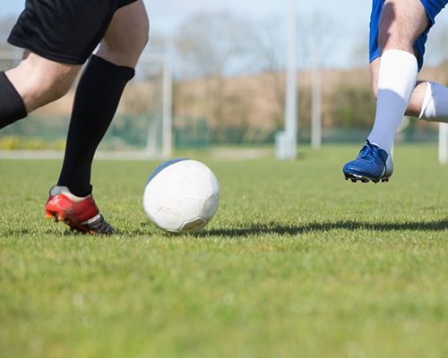 two footballers preparing to tackle