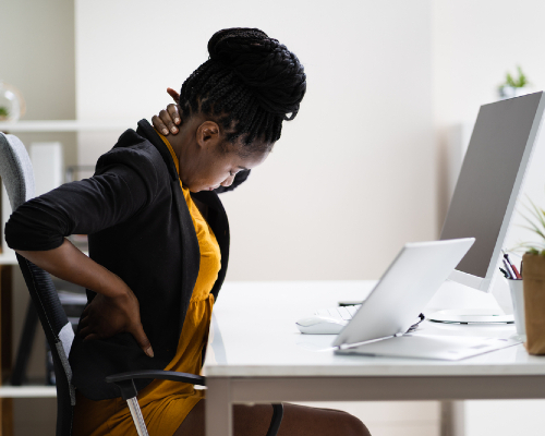 Lady with neck pain sitting at an office desk