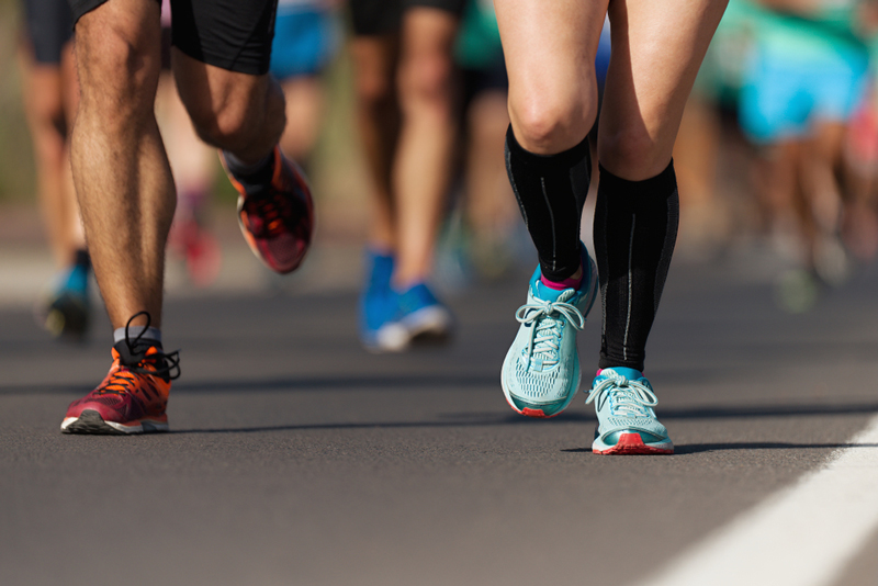 The knees of a crowd of marathon runners