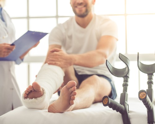 A male patient with a leg cast at a hospital